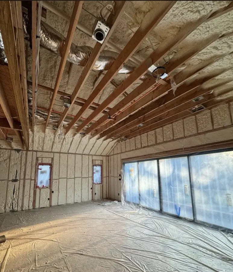 Interior walls and ceiling insulated with spray foam during new construction in Chalco